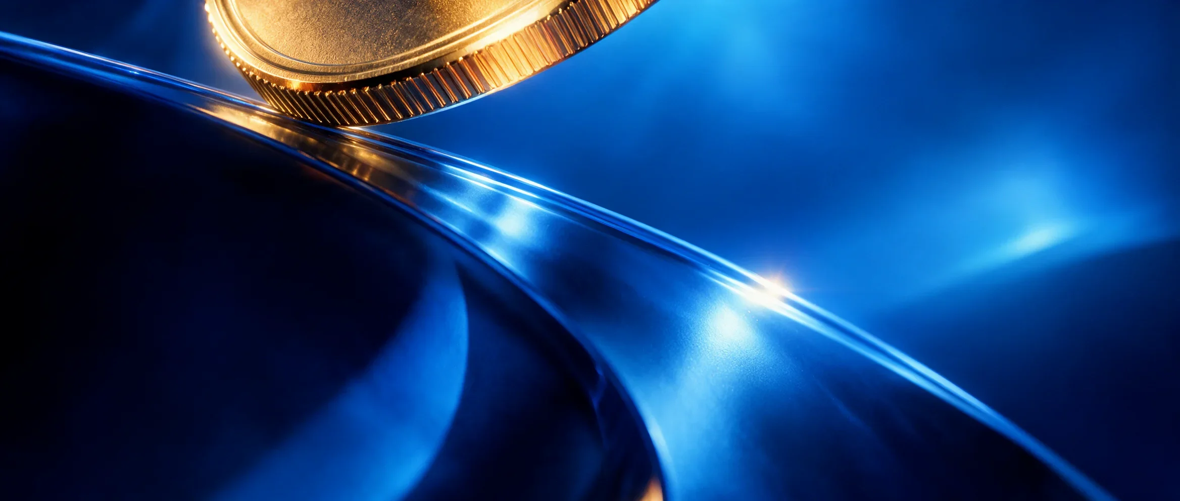 Gold Moon coin detail against a flowing blue reflective surface