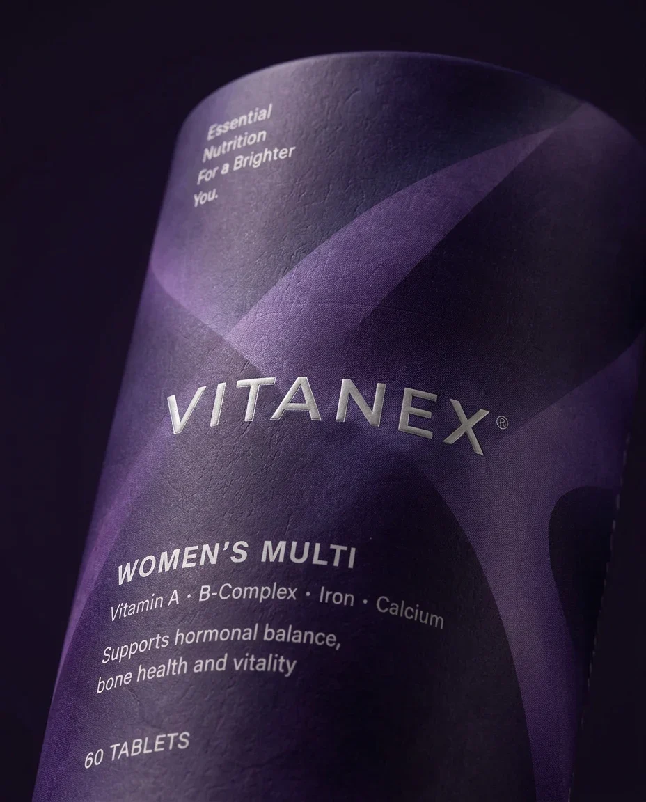 Close-up of purple Vitanex Women’s Multi packaging showing the wordmark and layered pattern